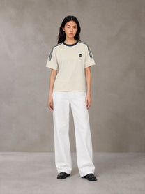 Model wearing SM Sig. Striped T-shirt in Natural Flax, front view.