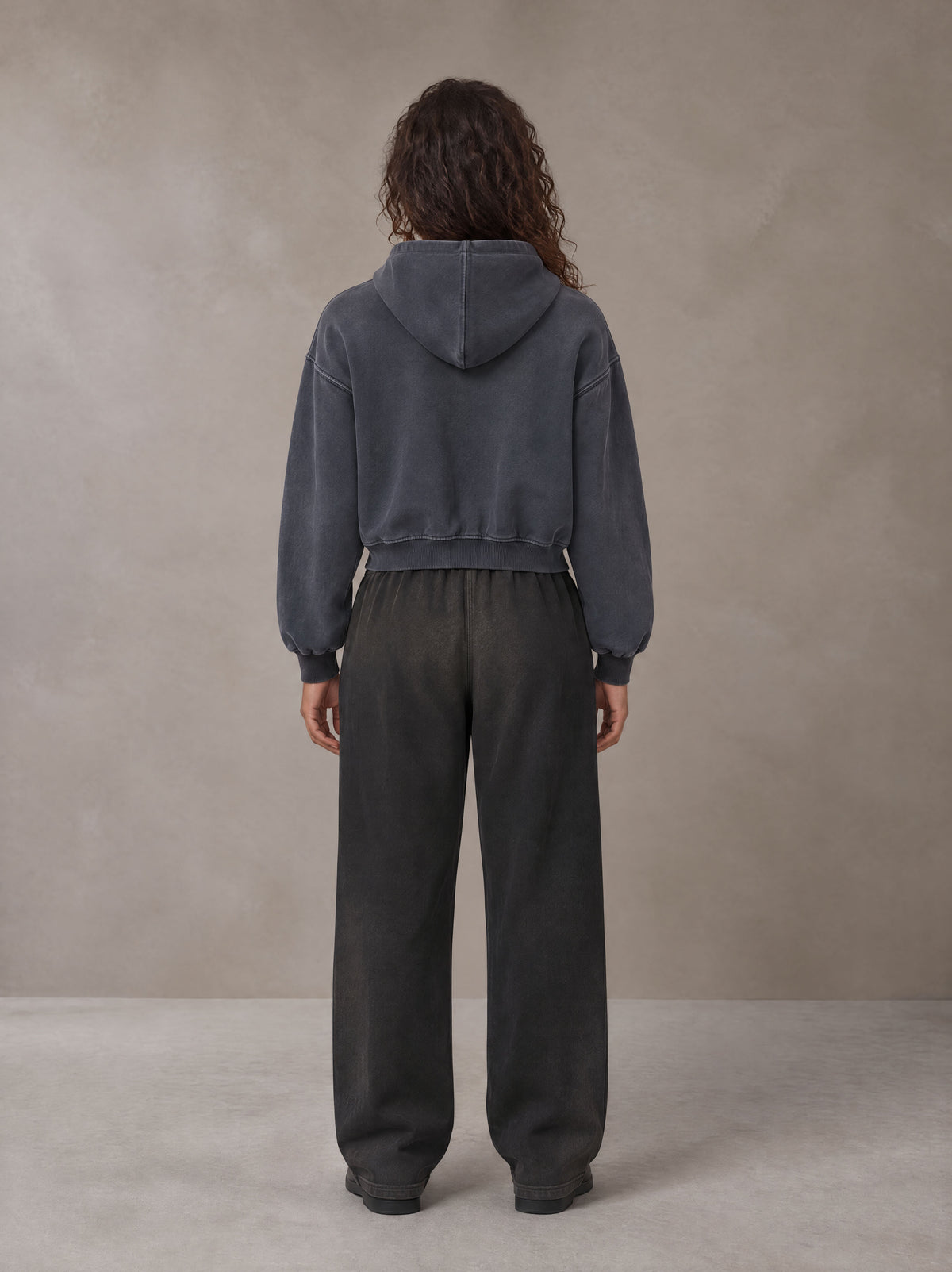 Model wearing SM Sig. Sunfade Boxy Hoodie in Chambray, rear view.