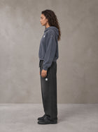 Model wearing SM Sig. Sunfade Boxy Hoodie in Chambray, side profile.