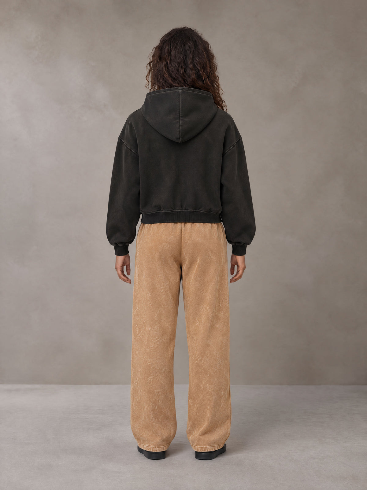 Model wearing SM Sig. Sunfade Boxy Hoodie in Midnight Black, rear view.