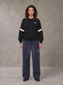 Model wearing SM Sig. Tempo Sweatshirt in Midnight Black, front view.