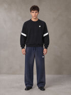Model wearing SM Sig. Tempo Sweatshirt in Midnight Black, front view.