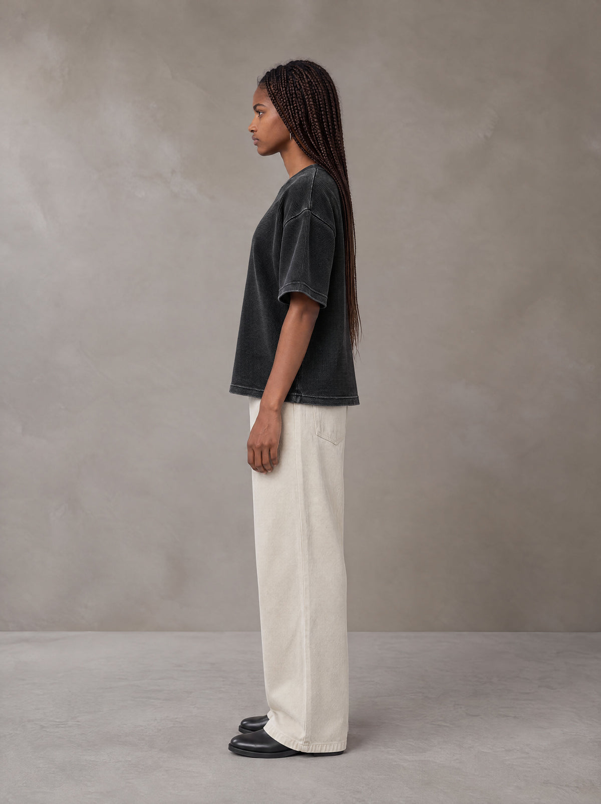 Model wearing SM Sig. Waffle Washed Boxy T-shirt in Midnight Black, side profile.