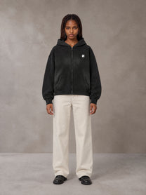 Model wearing SM Sig. Washed Boxy Hoodie in Midnight Black, front view.