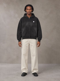Model wearing SM Sig. Washed Boxy Hoodie in Midnight Black, front view.
