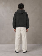 Model wearing SM Sig. Washed Boxy Hoodie in Midnight Black, rear view.