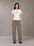 Model wearing SM Silk Logo T-shirt in Lucent White, front view.