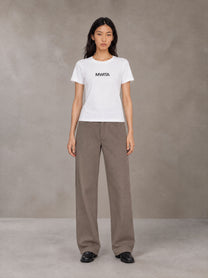 Model wearing SM Silk Logo T-shirt in Lucent White, front view.