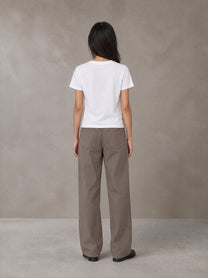 Model wearing SM Silk Logo T-shirt in Lucent White, rear view.