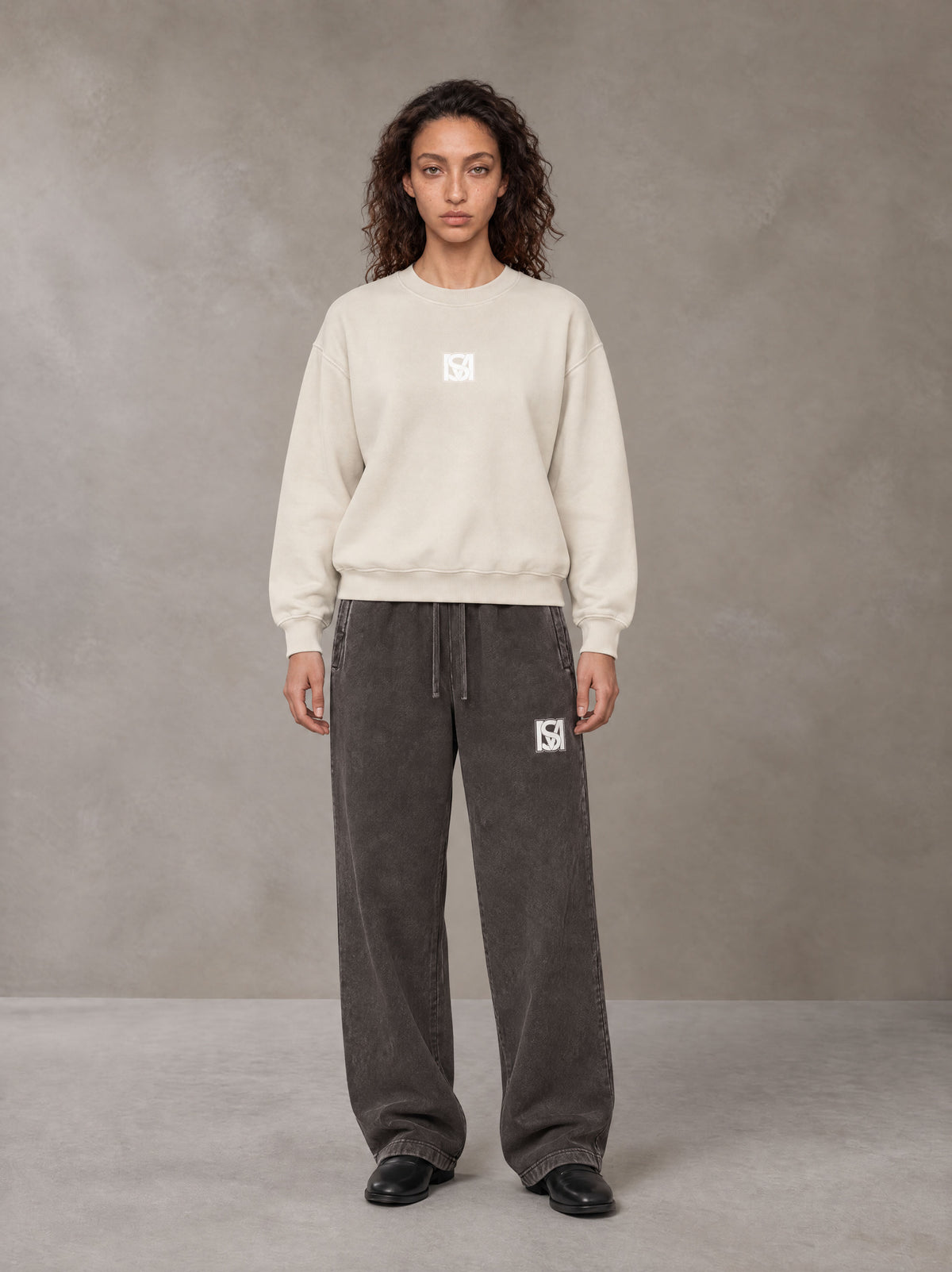 Model wearing SM Sunfade Fleeced Sweatshirt in Classic Cream, front view.
