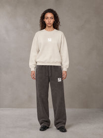 Model wearing SM Sunfade Fleeced Sweatshirt in Classic Cream, front view.