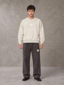 Model wearing SM Sunfade Fleeced Sweatshirt in Classic Cream, front view.