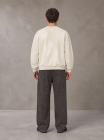 Model wearing SM Sunfade Fleeced Sweatshirt in Classic Cream, rear view.