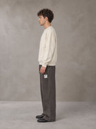 Model wearing SM Sunfade Fleeced Sweatshirt in Classic Cream, side profile.
