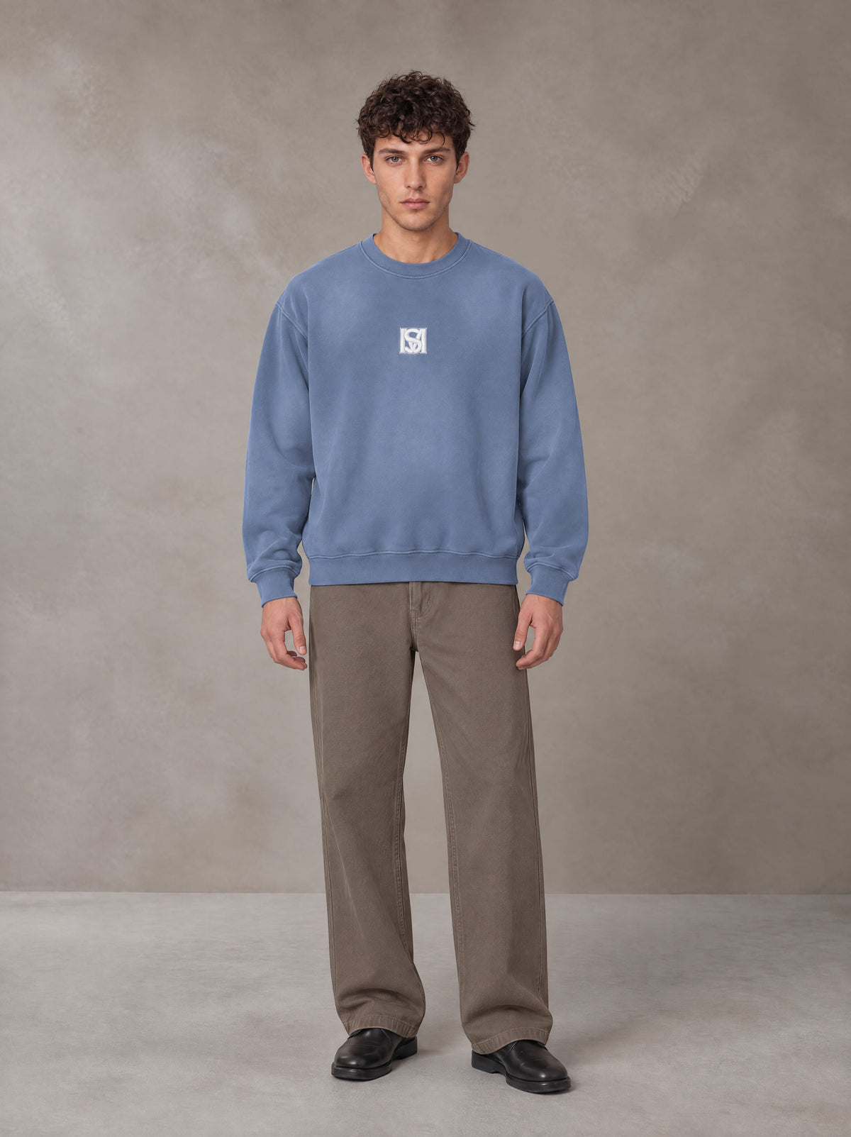 Model wearing SM Sunfade Fleeced Sweatshirt in Deep Denim, front view.