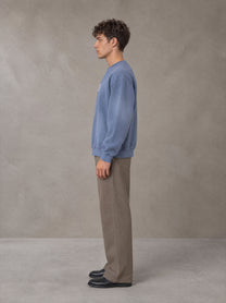 Model wearing SM Sunfade Fleeced Sweatshirt in Deep Denim, side profile.