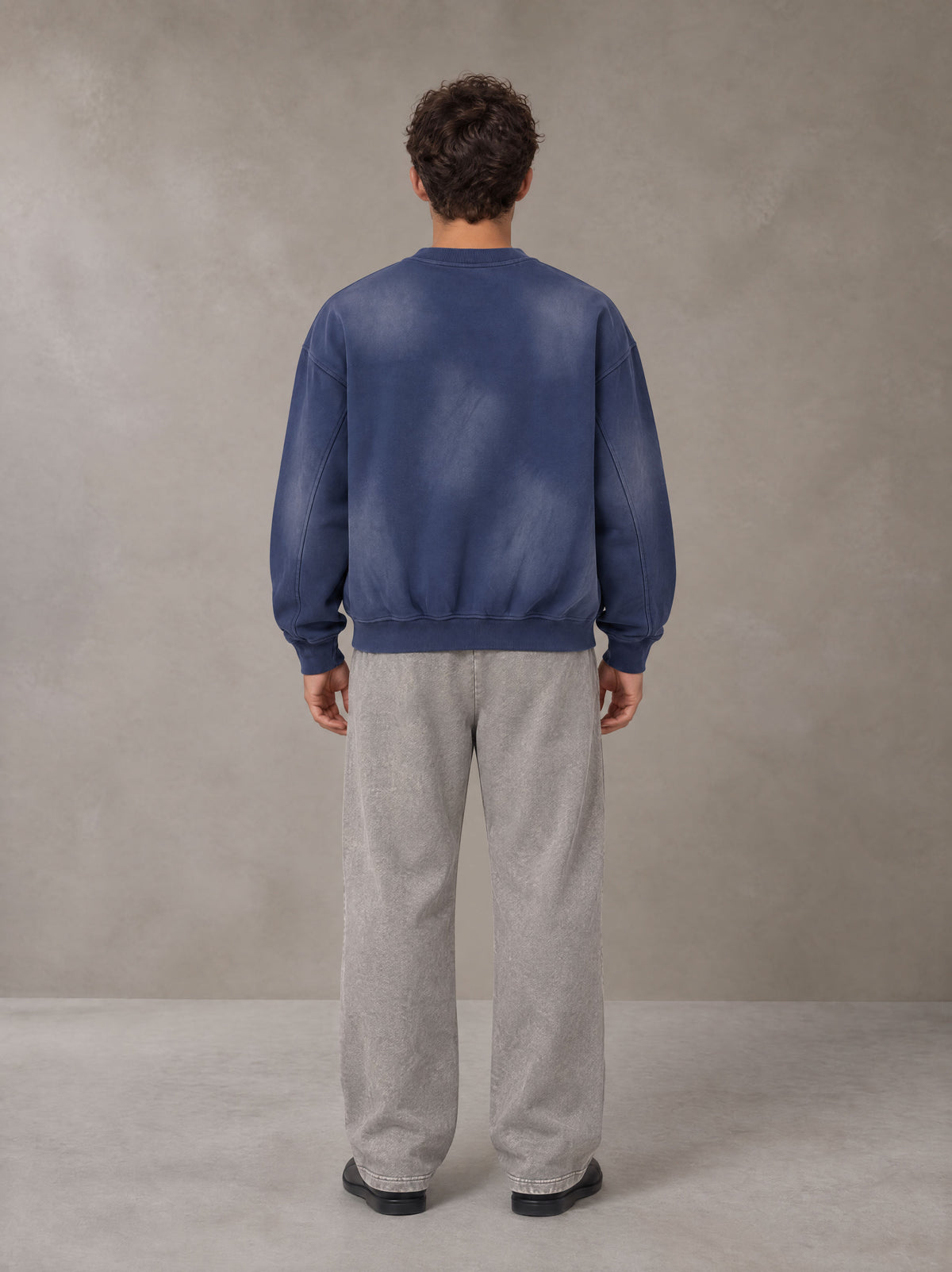 Model wearing SM Sunfade Fleeced Sweatshirt in Oxford Navy, rear view.