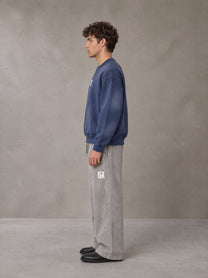Model wearing SM Sunfade Fleeced Sweatshirt in Oxford Navy, side profile.