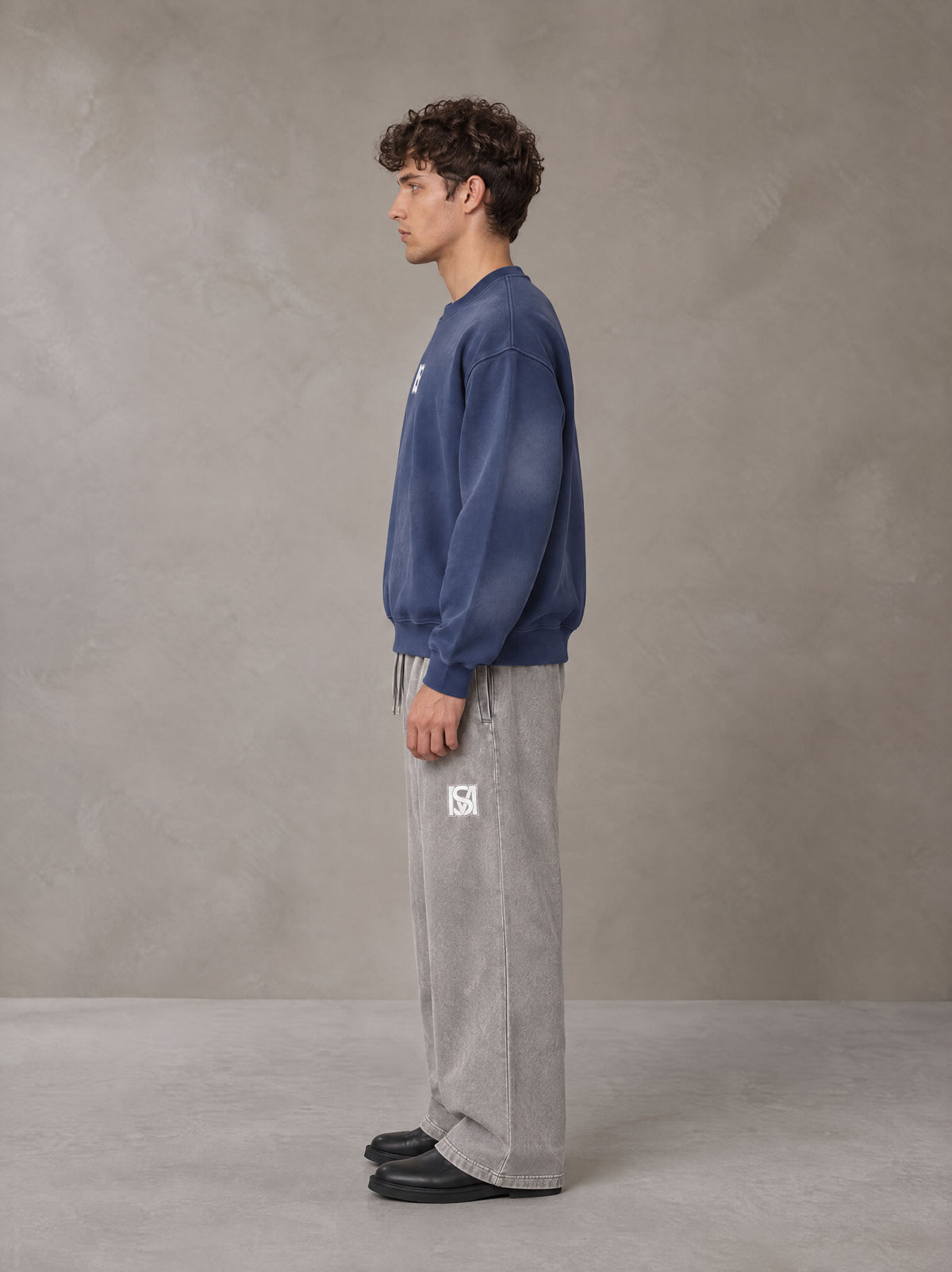 Model wearing SM Sunfade Fleeced Sweatshirt in Oxford Navy, side profile.