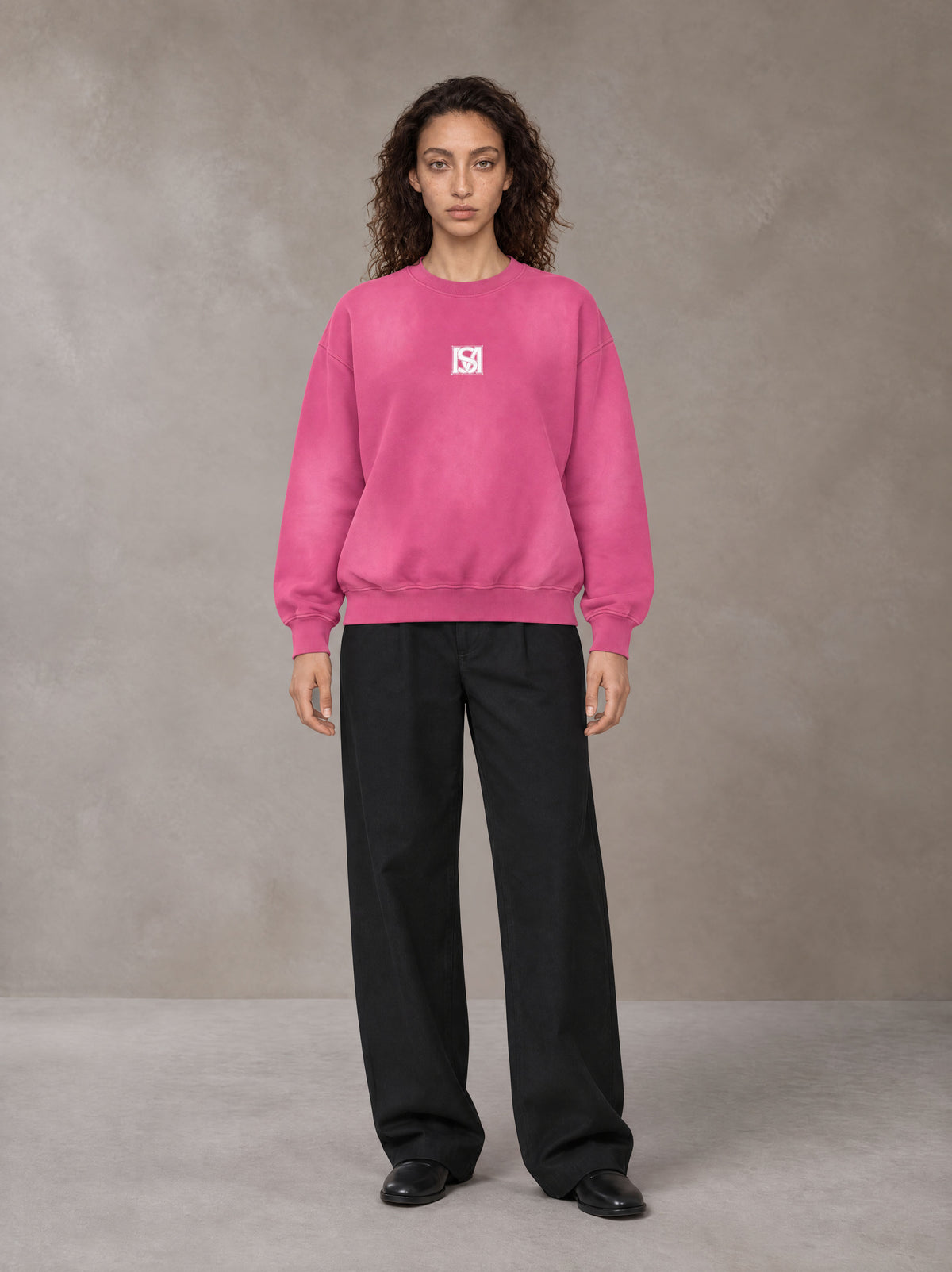 Model wearing SM Sunfade Fleeced Sweatshirt in Vivid Pink, front view.