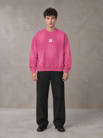 Model wearing SM Sunfade Fleeced Sweatshirt in Vivid Pink, front view.