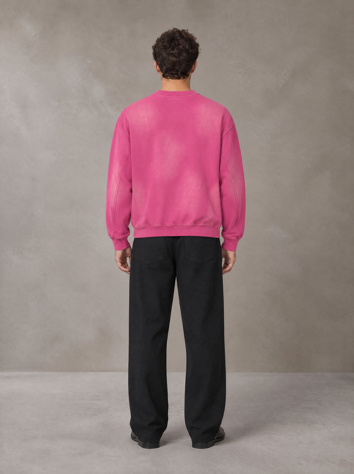 Model wearing SM Sunfade Fleeced Sweatshirt in Vivid Pink, rear view.