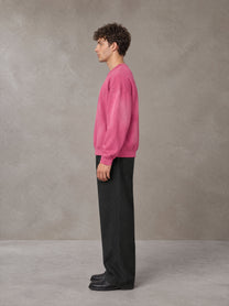 Model wearing SM Sunfade Fleeced Sweatshirt in Vivid Pink, side profile.