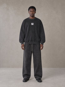 Model wearing the SM Acid Wash Sweatshirt and SM Acid Wash Trousers in Midnight Black, front view.