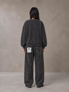 Model wearing the SM Acid Wash Sweatshirt and SM Acid Wash Trousers in Midnight Black, rear view.