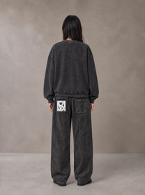 Model wearing the SM Acid Wash Sweatshirt and SM Acid Wash Trousers in Midnight Black, rear view.