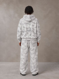 Model wearing the SM Cloud Fade Hoodie and SM Cloud Fade Sweatpants in Cloud Fade, rear view.