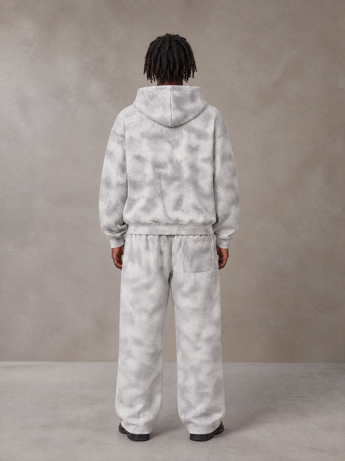 Model wearing the SM Cloud Fade Hoodie and SM Cloud Fade Sweatpants in Cloud Fade, rear view.