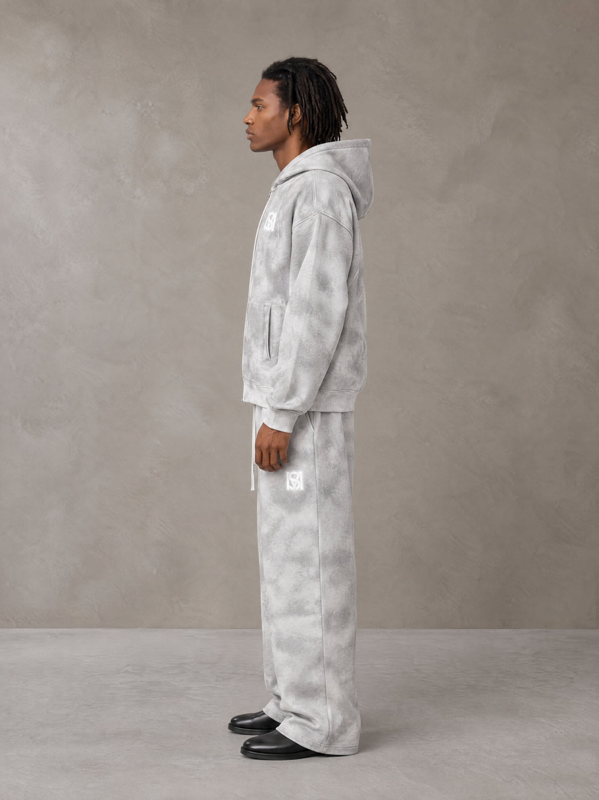 Model wearing the SM Cloud Fade Hoodie and SM Cloud Fade Sweatpants in Cloud Fade, side profile.