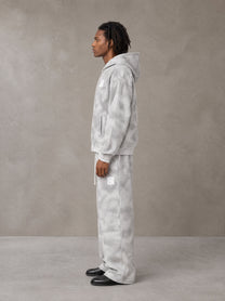 Model wearing the SM Cloud Fade Hoodie and SM Cloud Fade Sweatpants in Cloud Fade, side profile.