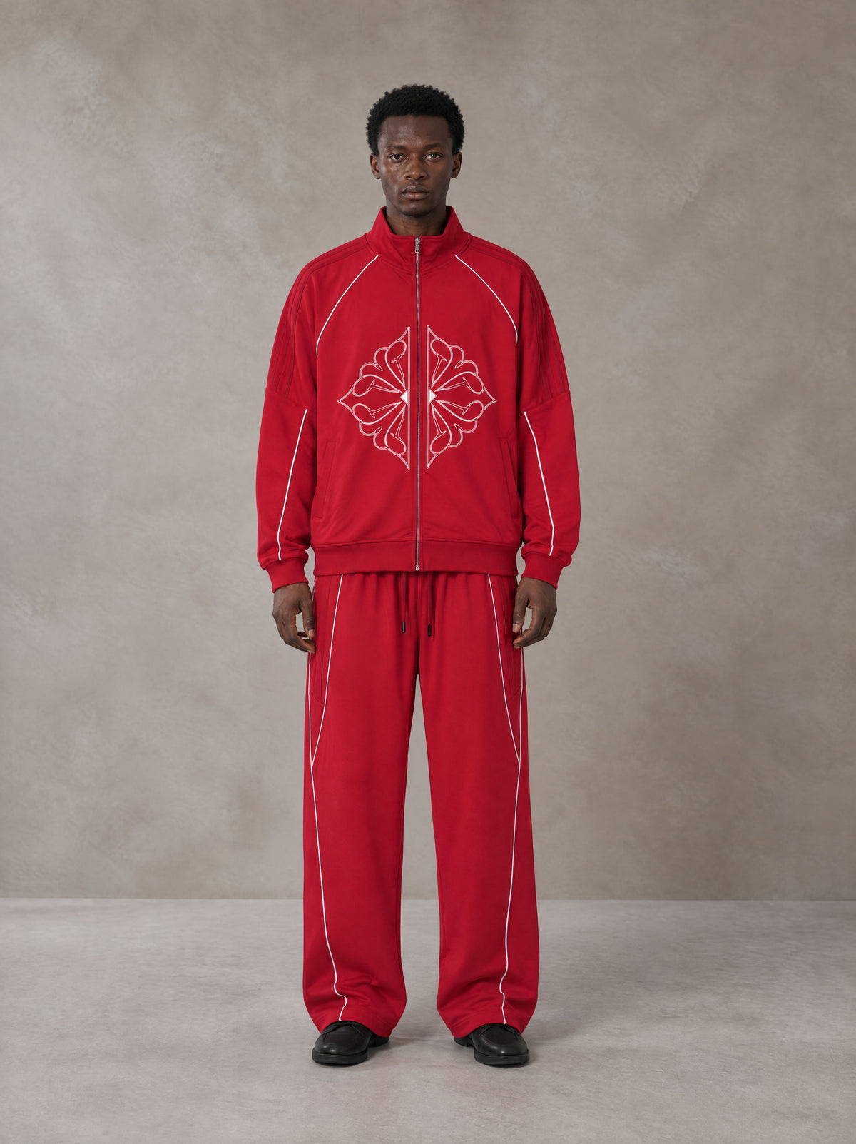 Model wearing the SM Fleur Eclipse Jacket and SM Fleur Eclipse Sweatpants in Crimson, front view.