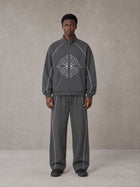 Model wearing the SM Fleur Eclipse Jacket and SM Fleur Eclipse Sweatpants in Deep Charcoal, front view.