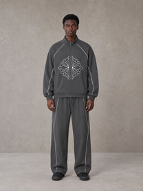 Model wearing the SM Fleur Eclipse Jacket and SM Fleur Eclipse Sweatpants in Deep Charcoal, front view.