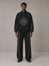 Model wearing the SM Fleur Eclipse Jacket and SM Fleur Eclipse Sweatpants in Midnight Black, front view.