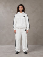 Model wearing the SM Insignia Utility Hoodie and SM Insignia Utility Sweatpants in Lucent White, front view.