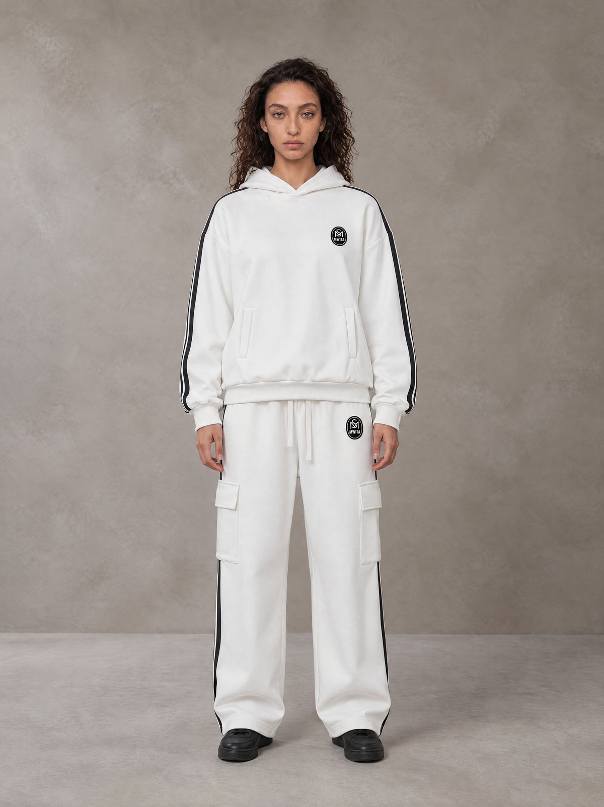 Model wearing the SM Insignia Utility Hoodie and SM Insignia Utility Sweatpants in Lucent White, front view.