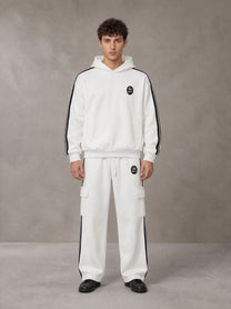 Model wearing the SM Insignia Utility Hoodie and SM Insignia Utility Sweatpants in Lucent White, front view.