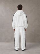Model wearing the SM Insignia Utility Hoodie and SM Insignia Utility Sweatpants in Lucent White, rear view.