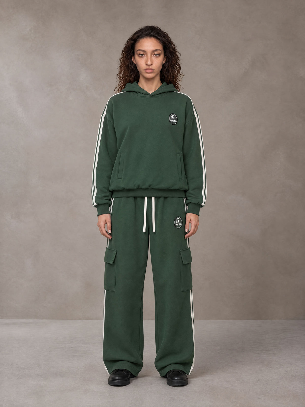 Model wearing the SM Insignia Utility Hoodie and SM Insignia Utility Sweatpants in Lunar Green, front view.