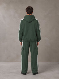 Model wearing the SM Insignia Utility Hoodie and SM Insignia Utility Sweatpants in Lunar Green, rear view.