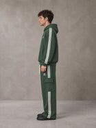 Model wearing the SM Insignia Utility Hoodie and SM Insignia Utility Sweatpants in Lunar Green, side profile.
