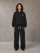 Model wearing the SM Insignia Utility Hoodie and SM Insignia Utility Sweatpants in Midnight Black, front view.
