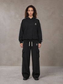 Model wearing the SM Insignia Utility Hoodie and SM Insignia Utility Sweatpants in Midnight Black, front view.