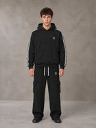 Model wearing the SM Insignia Utility Hoodie and SM Insignia Utility Sweatpants in Midnight Black, front view.