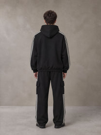 Model wearing the SM Insignia Utility Hoodie and SM Insignia Utility Sweatpants in Midnight Black, rear view.