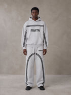 Model wearing the SM Track Line Hoodie and SM Track Line Sweatpants in Floral Grey, front view.